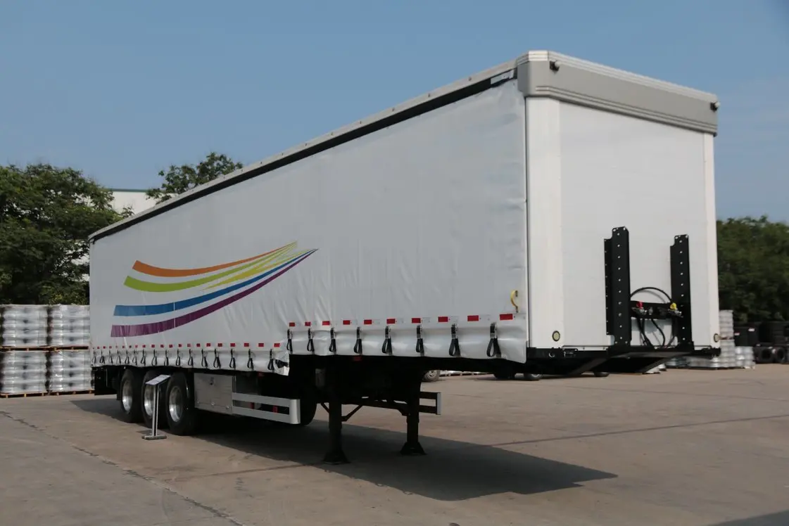 Front 45-degree view of Kales 13M Curtainsider semi-trailer featuring aerodynamic chamfered corners to reduce wind resistance.