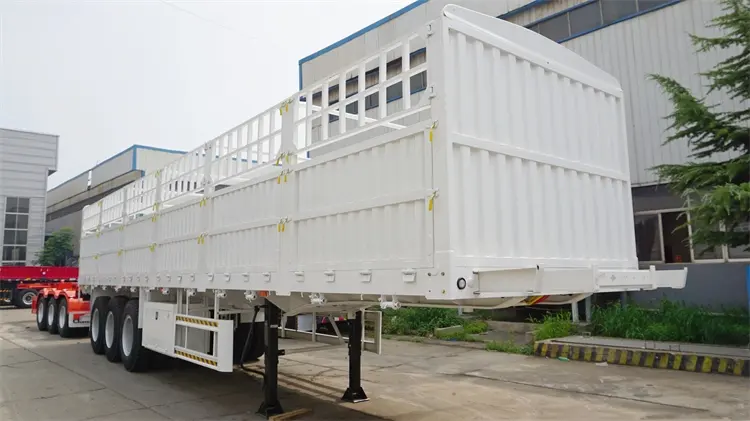 Front 45-degree view of Kales 60-ton fence semi-trailer featuring side tool box and safety guard rails.