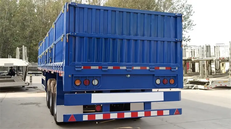 Rear detail of Kales dropside trailer featuring LED lights with protective guards, reinforced bumper, and openable tailgate.